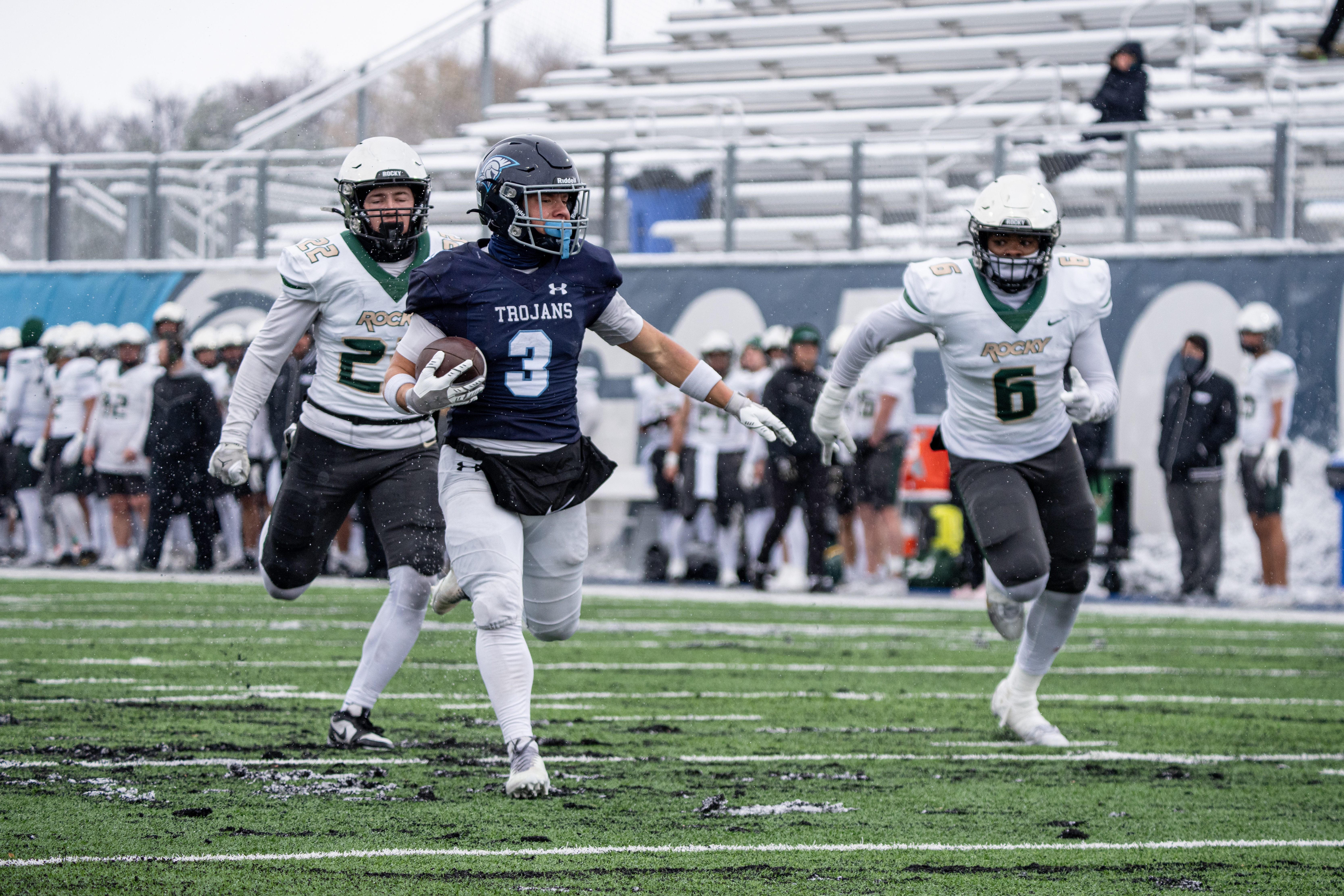 DSU football players run on the field. 