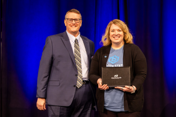 Addie Borah, on the right, receives an award from XXJason Howell, on the left, at StartTodaySD Apprenticeship Summit