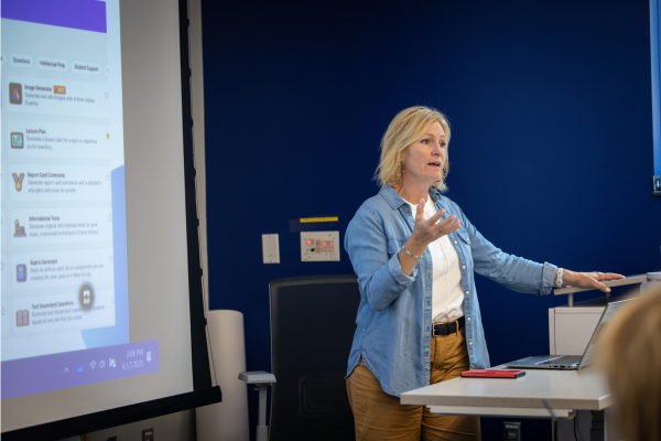 Betsy Schamber, DSU Professor, teaching at podium during 2025 cyber camp for teachers