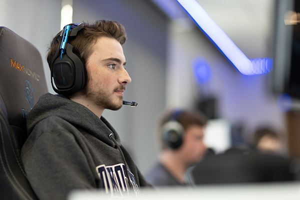 Student with headset on playing video games
