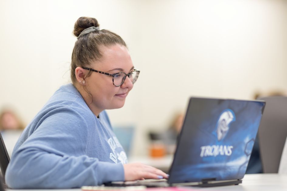 dsu student in class looking at laptop
