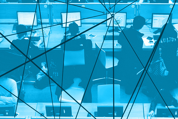 A computer lab with rows of four desks, each occupied by students working at computers. Overlaying the computer lab are lines connecting through nodes, symbolizing the flow of communication, data exchange, and interconnected networks. 