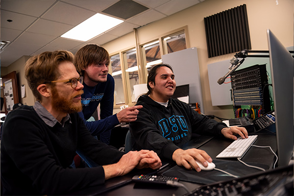 professor and students working on a project