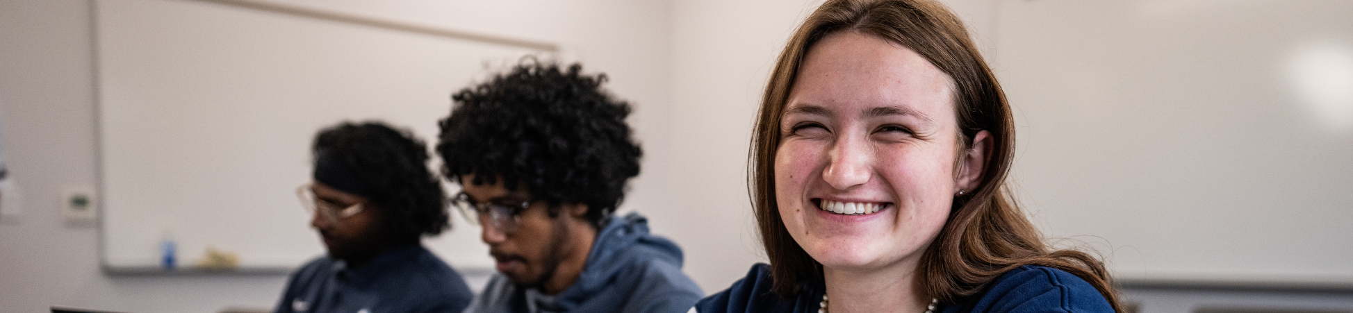 dsu student smiling at camera in classroom