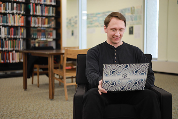 student working on laptop in the library