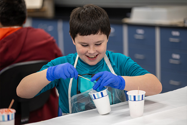 Elementary student doing an experiment in the lab