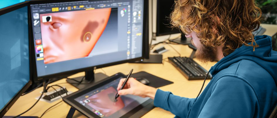 computer game design student working on animation in class