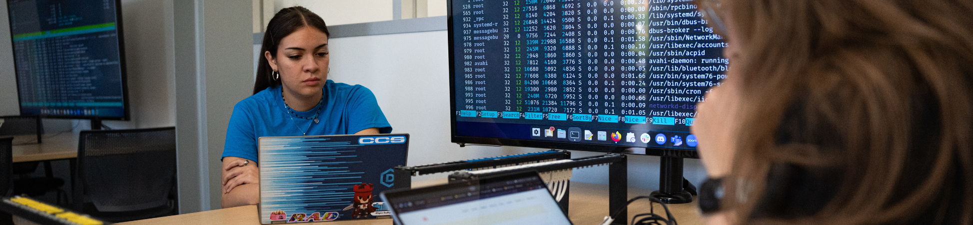 student working on laptop with code screen