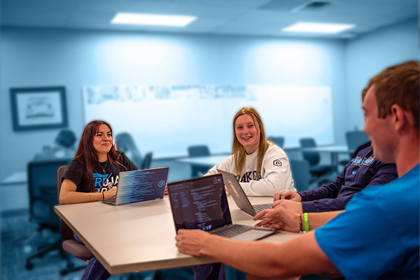 Group of students talking amongst themselves in class