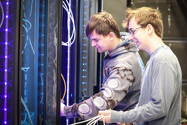 Cyber operations students working in a server room.