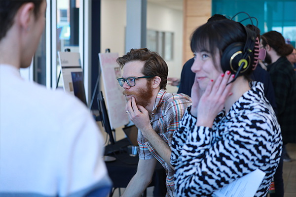 Digital sound design student wearing headphones.