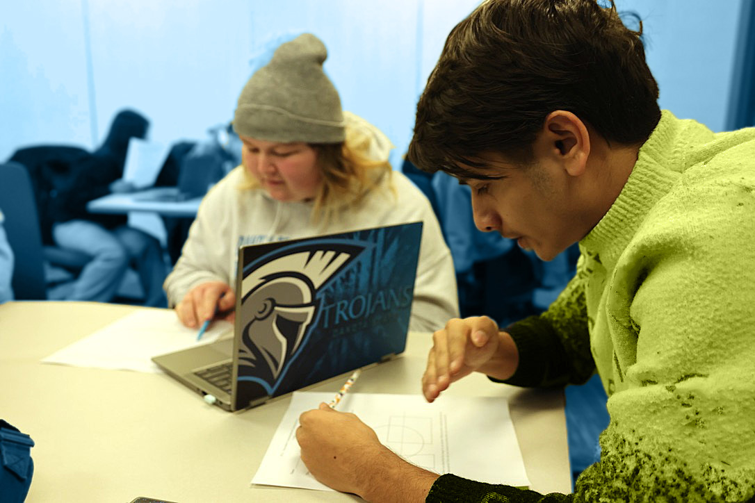 Two DSU students doing classwork in classroom.