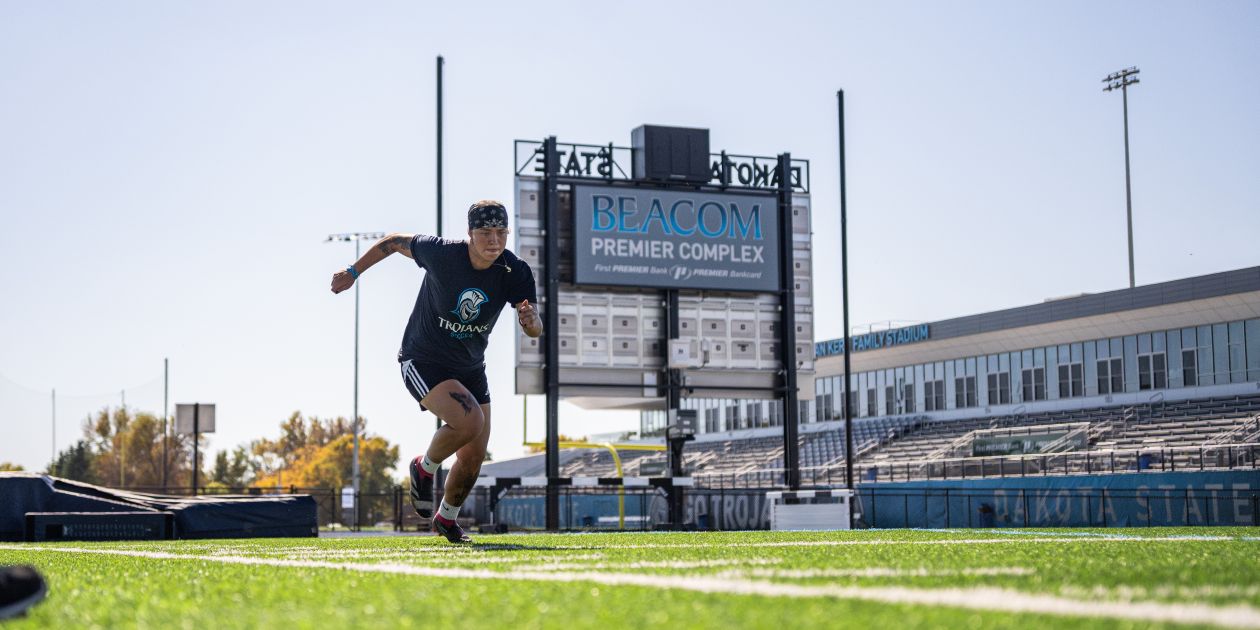 exercise science student running on football field