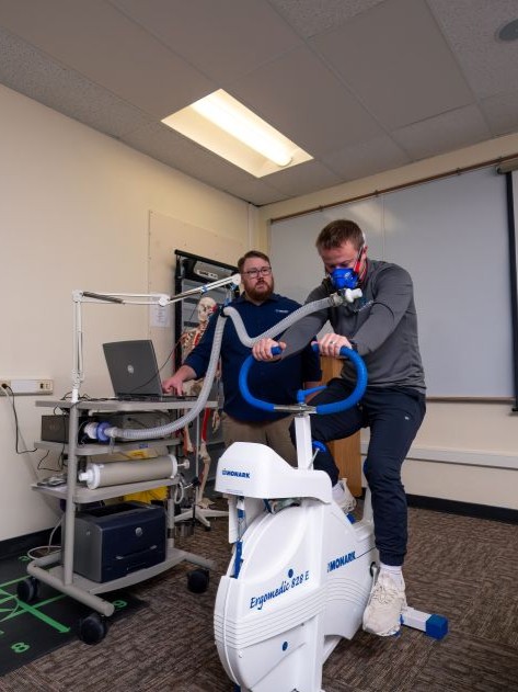 exercise science student riding bike