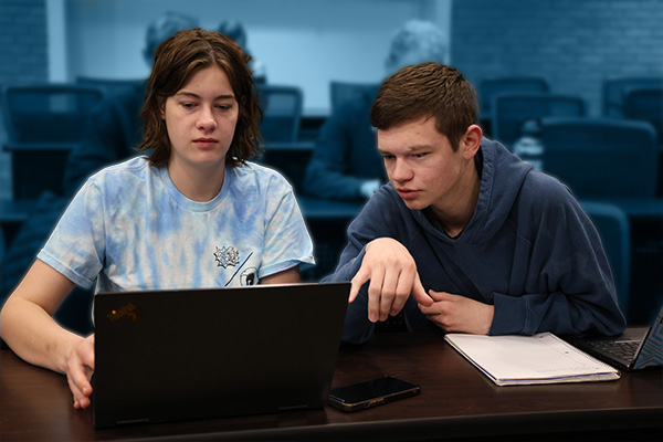 High-performance computing students working at a computer