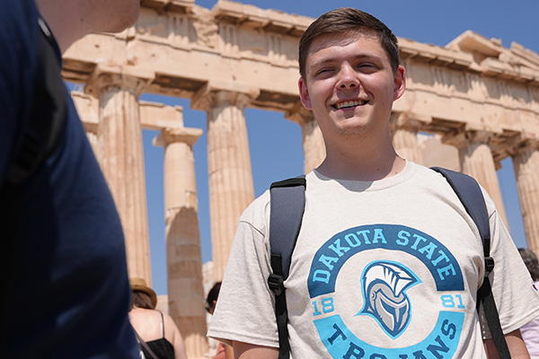 History minor student posing in front of ancient Greek ruins