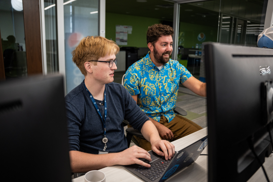 dsu msai student and professor working on computer in madlabs