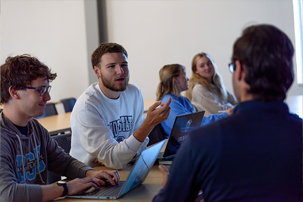 A computer science masters student asks a question of the professor.