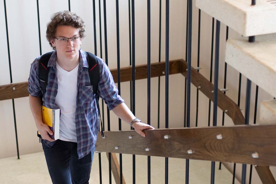 HIM student climbing stairs on campus
