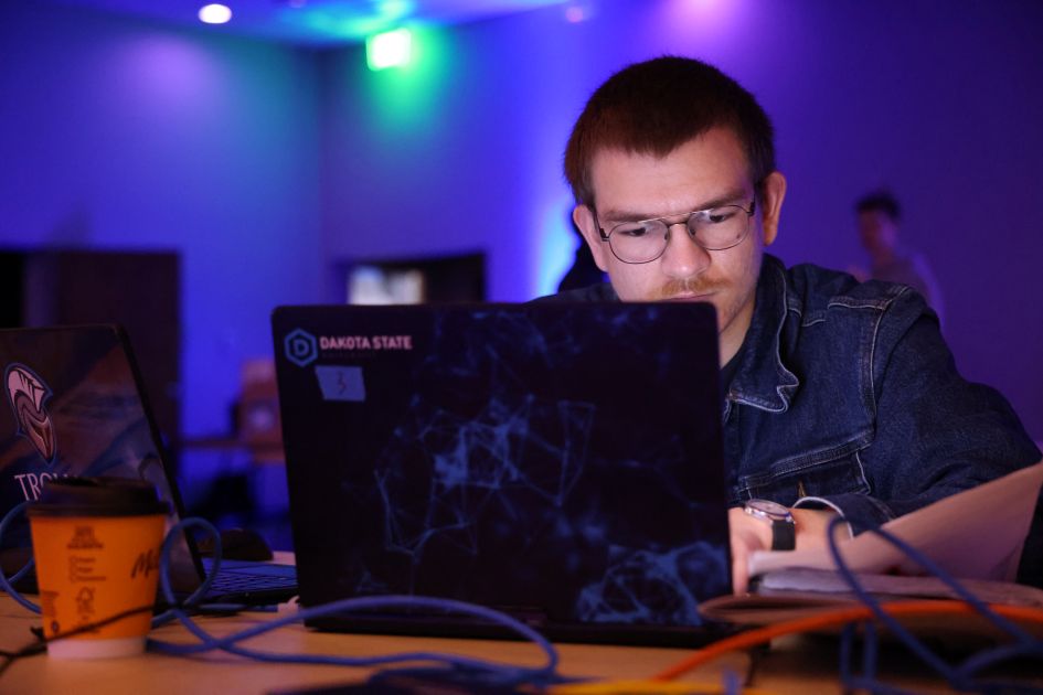 student working on laptop on dakotacon