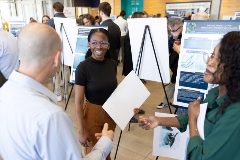 Student showcasing their work at the Research Symposium