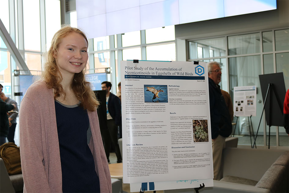 Student showcasing their work at the Research Symposium