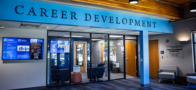 The DSU Career development office exterior featuring welcoming blue painted accents and tall clear windows encompassing the waiting area.