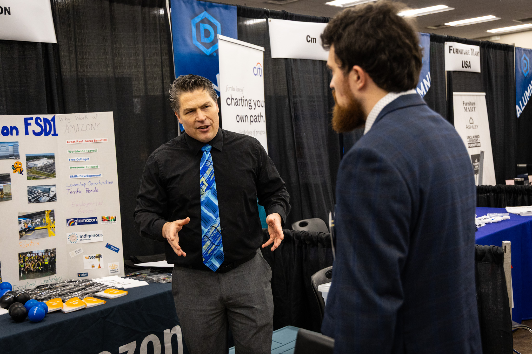 employer talking with student at career fair