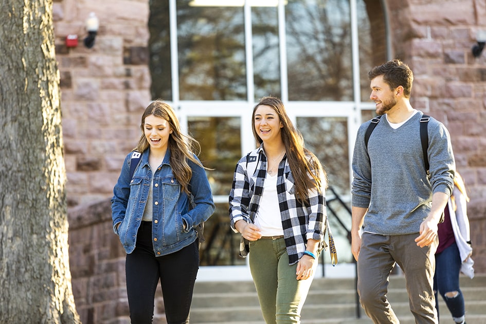 three students walking on campus