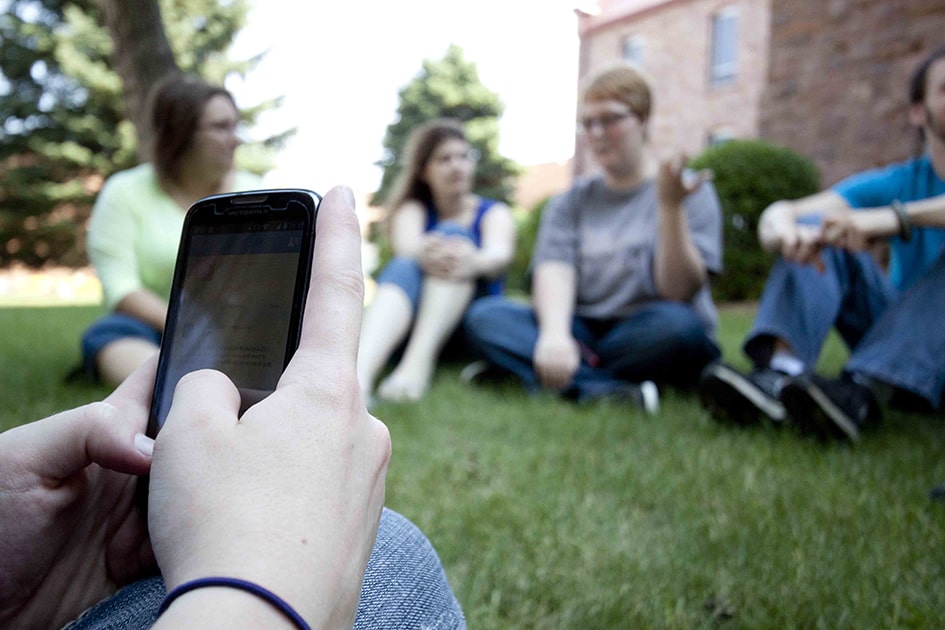 Students sitting on the East Lawn