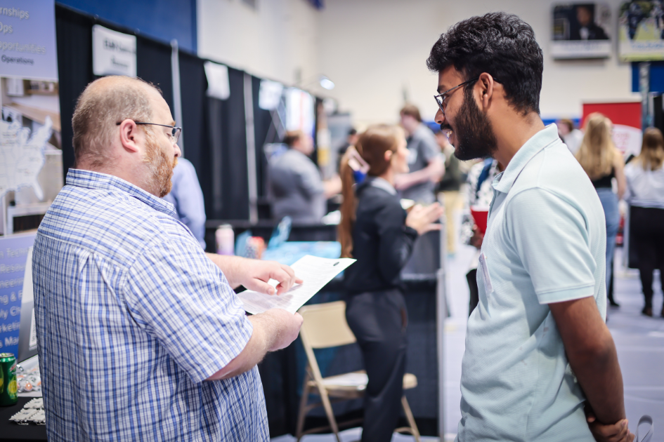 student talking with employer at career fair