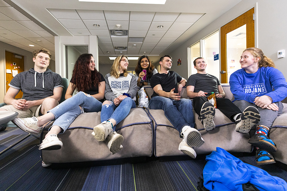 group of students sitting on cushions