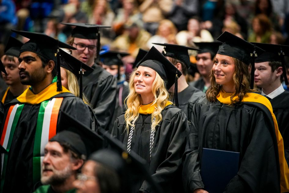 dsu graduates smiling at commencement ceremony