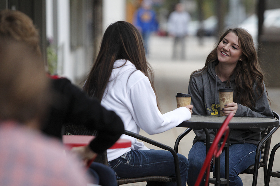 group of students sitting at a table talking