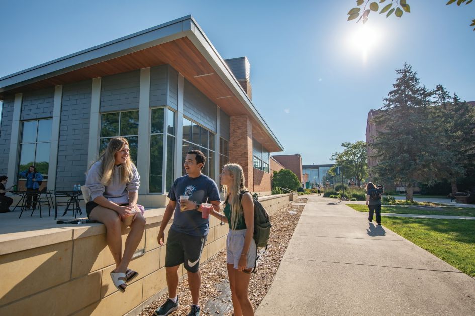 two dsu students on a field playing bean bags