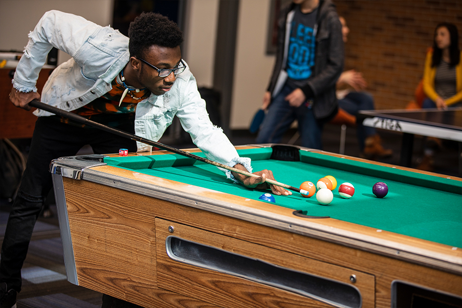 Student playing pool.