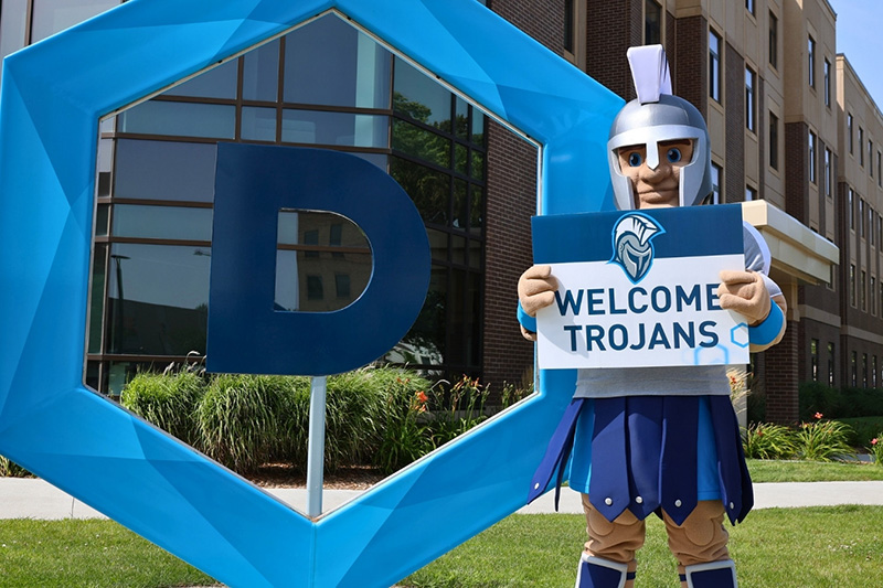 trojan mascot holding a welcome sign