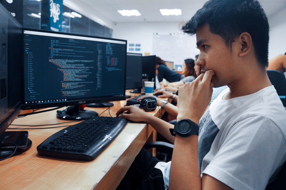 Student working on coding on desktop computer